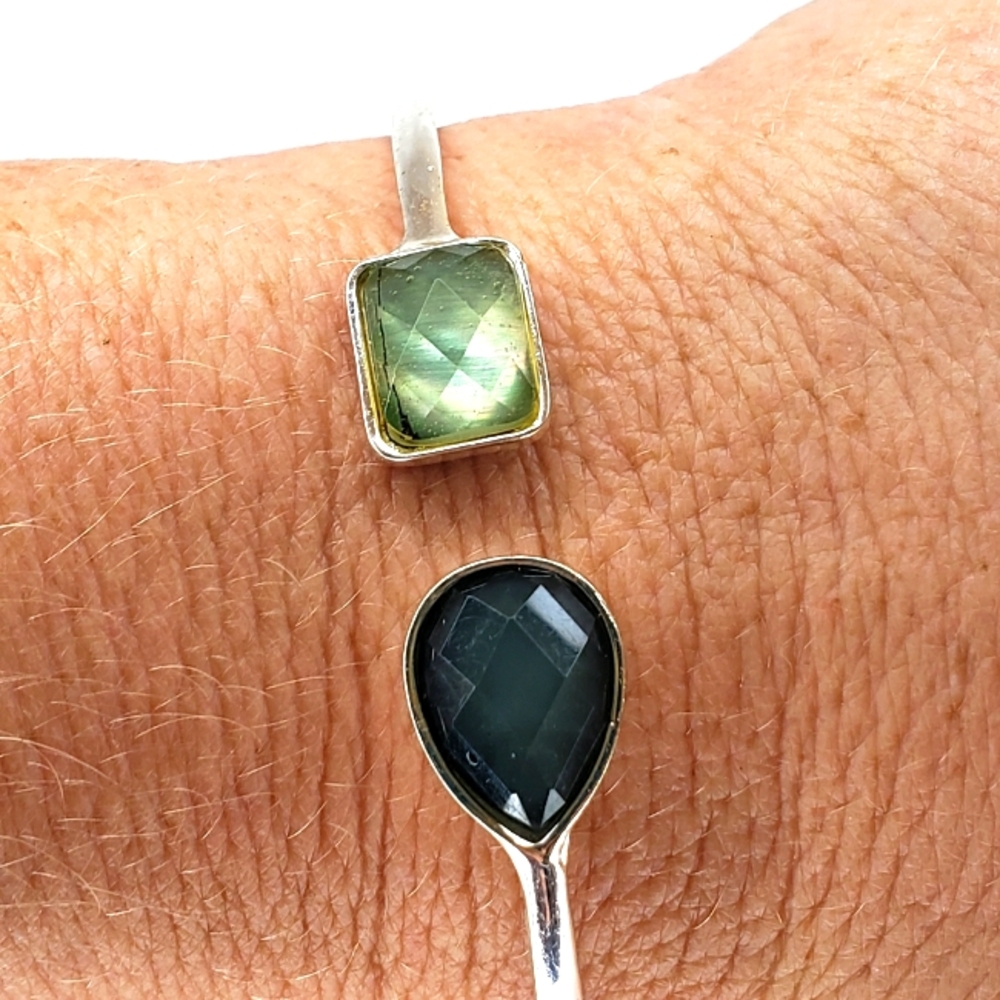 Silver colored bracelet with green and blue stones